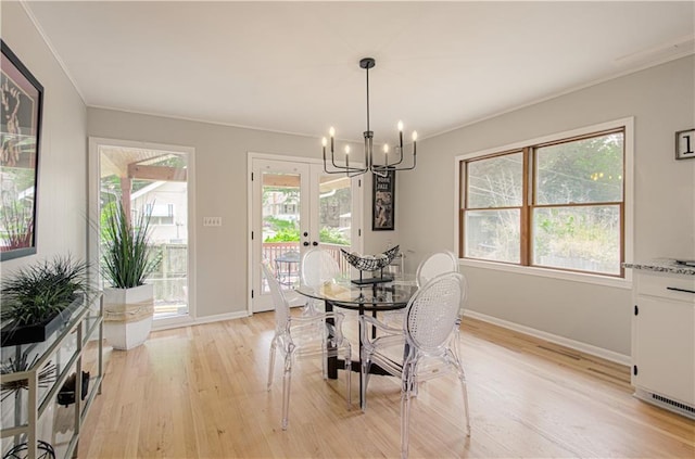 4547 Wyoming St, Kansas City, MO 64111 - dining area with a chandelier, light wood finished floors, baseboards, and crown molding