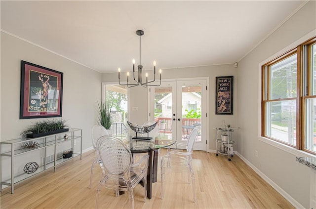 4547 Wyoming St, Kansas City, MO 64111 - dining area with crown molding, a chandelier, light wood-style floors, baseboards, and french doors