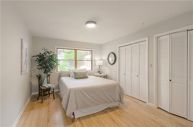 4547 Wyoming St, Kansas City, MO 64111 - bedroom with multiple closets, light wood-type flooring, and baseboards