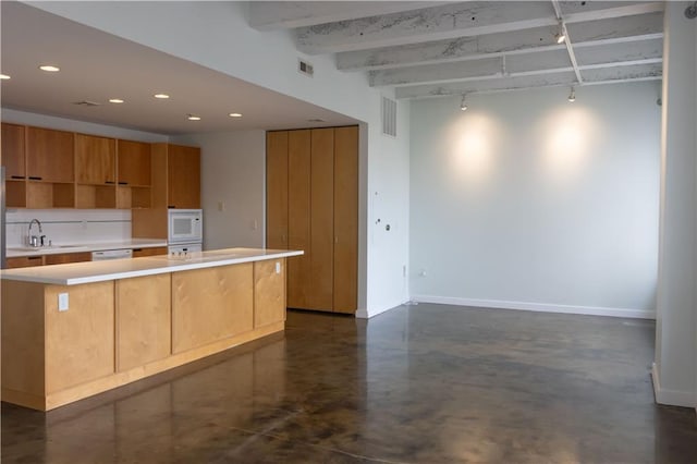 kitchen with a sink, white appliances, light countertops, concrete floors, and recessed lighting