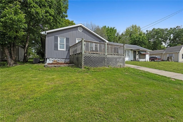 view of front of house with a front lawn, a deck, and central air condition unit
