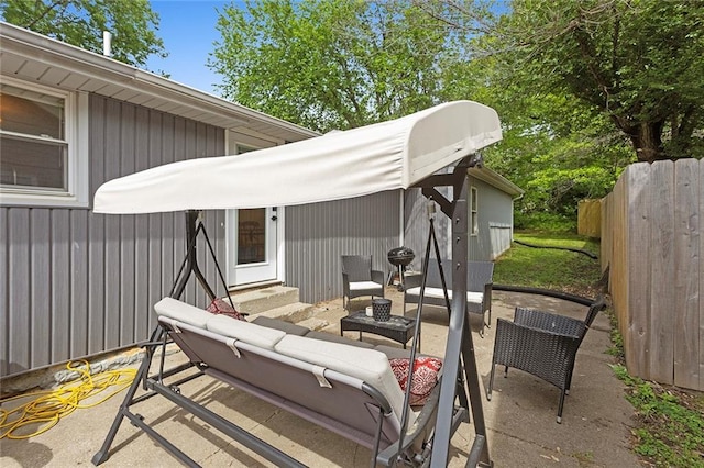 view of patio featuring an outdoor living space, entry steps, and fence
