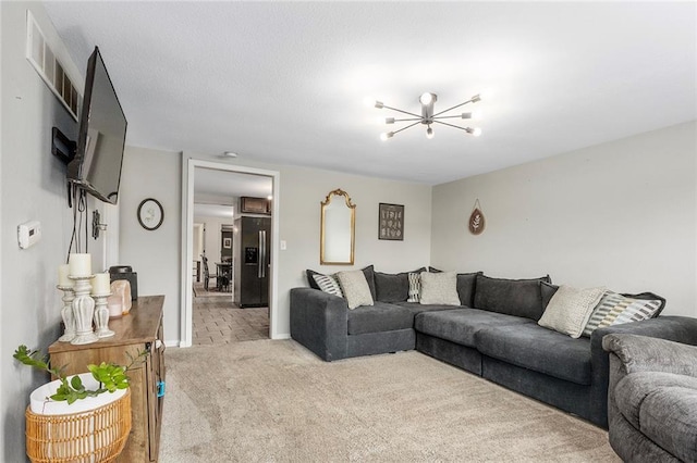 carpeted living area with a chandelier and baseboards