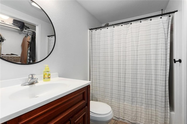 bathroom with toilet, vanity, and a shower with curtain