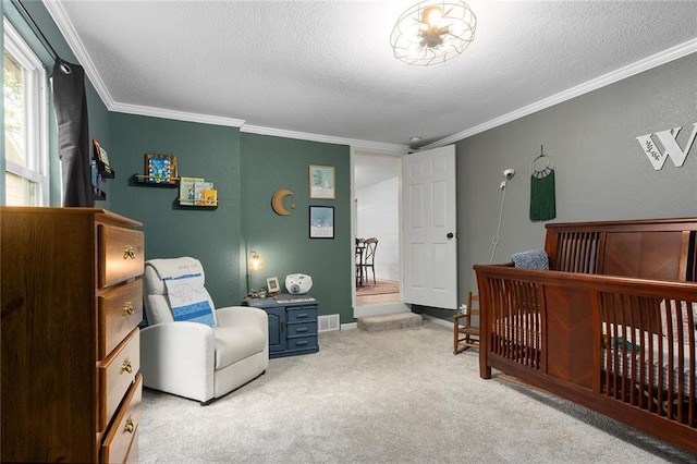 carpeted bedroom featuring a textured ceiling, crown molding, a nursery area, and baseboards