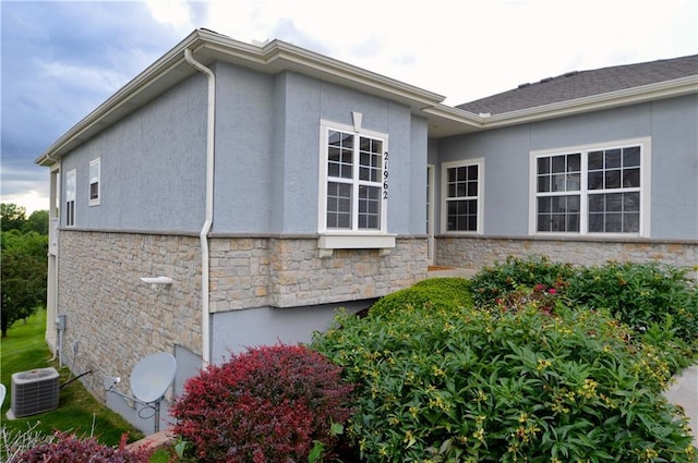 21962 W 116th Ter, Olathe, KS 66061 - view of home's exterior featuring stone siding and stucco siding