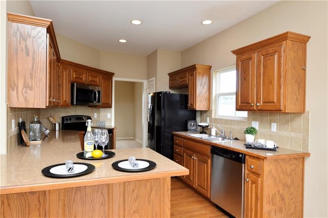 21962 W 116th Ter, Olathe, KS 66061 - kitchen featuring appliances with stainless steel finishes, light countertops, a peninsula, tasteful backsplash, and recessed lighting