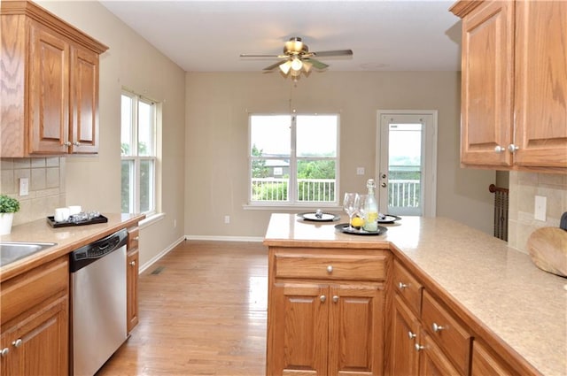 21962 W 116th Ter, Olathe, KS 66061 - kitchen featuring stainless steel dishwasher, light wood-style floors, tasteful backsplash, light countertops, and a ceiling fan