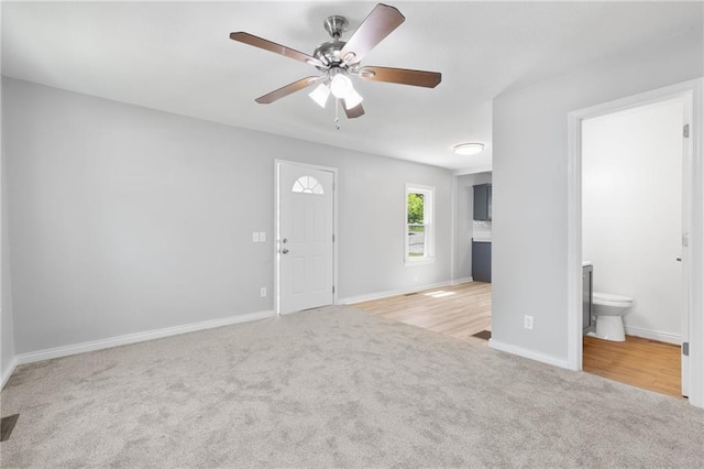 522 E Fair Ave, Independence, MO 64055 - unfurnished living room with carpet floors, a ceiling fan, and baseboards