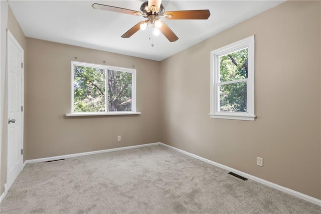 522 E Fair Ave, Independence, MO 64055 - carpeted spare room with plenty of natural light, ceiling fan, and baseboards