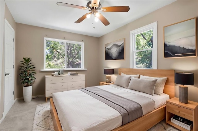 522 E Fair Ave, Independence, MO 64055 - bedroom with multiple windows, light carpet, baseboards, and a ceiling fan