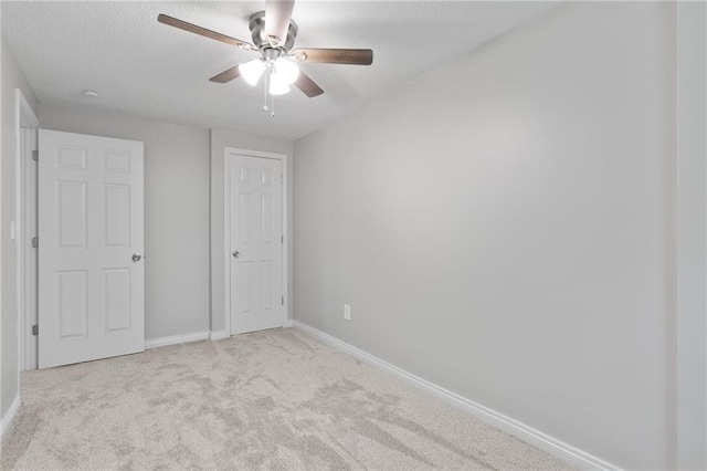 522 E Fair Ave, Independence, MO 64055 - unfurnished bedroom featuring carpet flooring, baseboards, a textured ceiling, and a ceiling fan