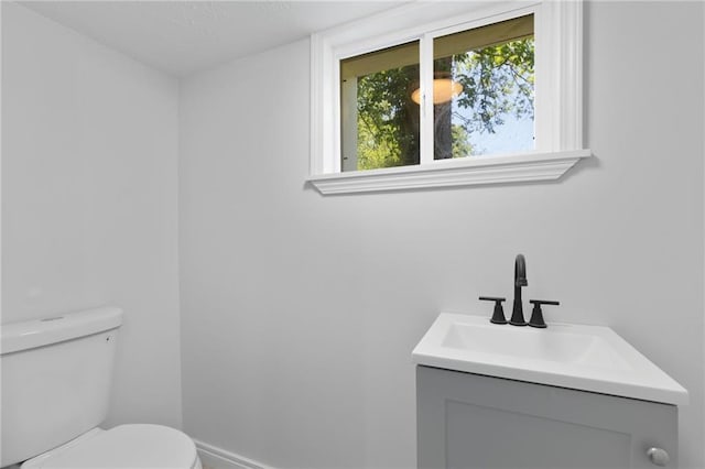 522 E Fair Ave, Independence, MO 64055 - bathroom with toilet, vanity, and baseboards