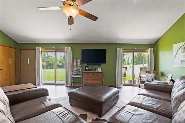 living area featuring ceiling fan and vaulted ceiling