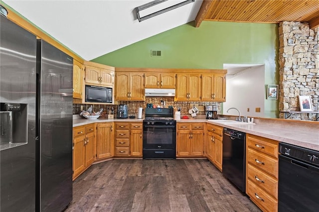 kitchen featuring black appliances, under cabinet range hood, a sink, dark wood finished floors, and light countertops