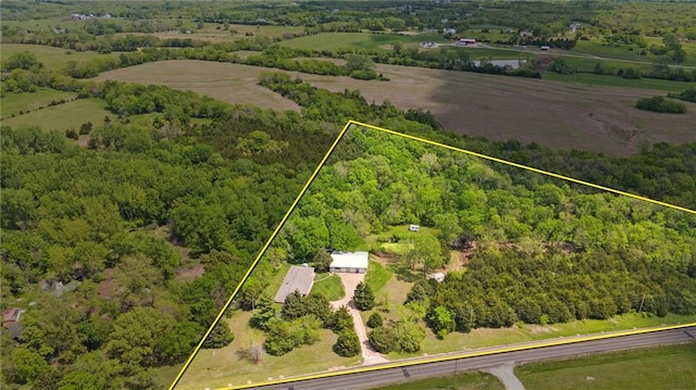 aerial view of sparsely populated area with property boundaries highlighted and a forest