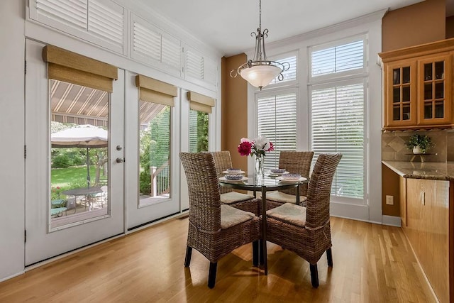 dining room with healthy amount of natural light and light wood-style floors