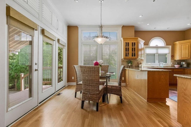 dining room featuring light wood-type flooring and recessed lighting