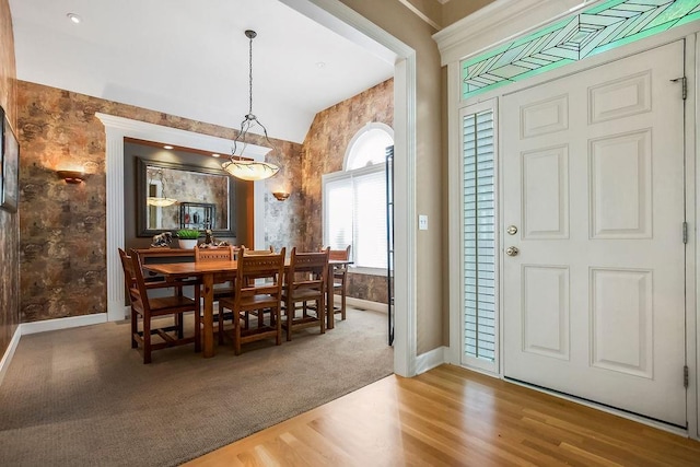 dining area with baseboards, wood finished floors, and wallpapered walls