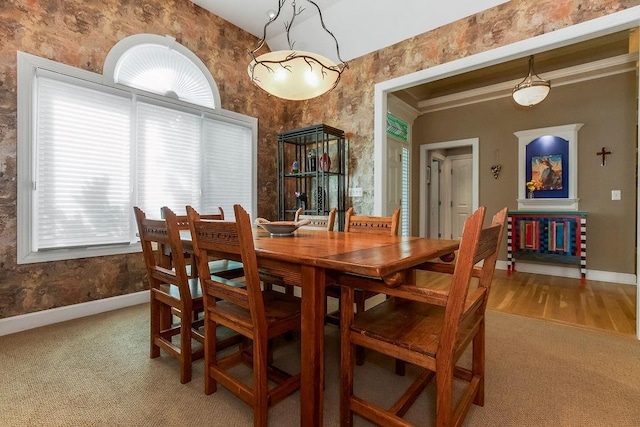 dining area with baseboards and carpet floors