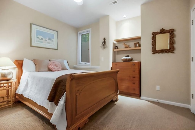 bedroom with light colored carpet and baseboards