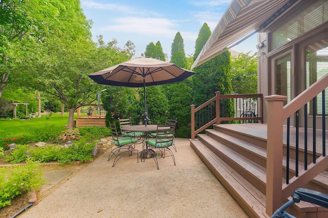 view of patio / terrace with a deck and outdoor dining area