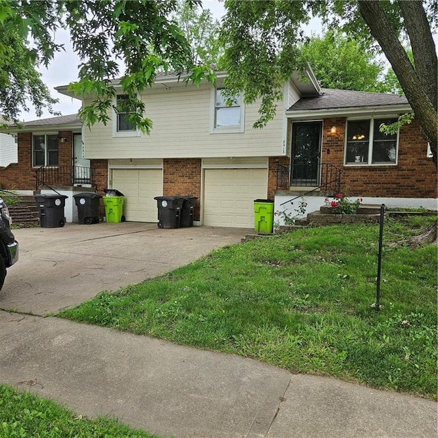 8413-8415 E 170th St, Belton, MO 64012 - split level home featuring an attached garage, brick siding, concrete driveway, and a front lawn
