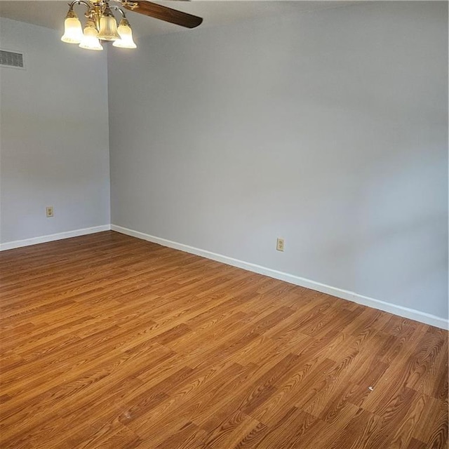 8413-8415 E 170th St, Belton, MO 64012 - empty room featuring wood finished floors, baseboards, a ceiling fan, and a chandelier