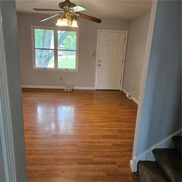 8413-8415 E 170th St, Belton, MO 64012 - entrance foyer featuring ceiling fan, wood finished floors, baseboards, and stairway