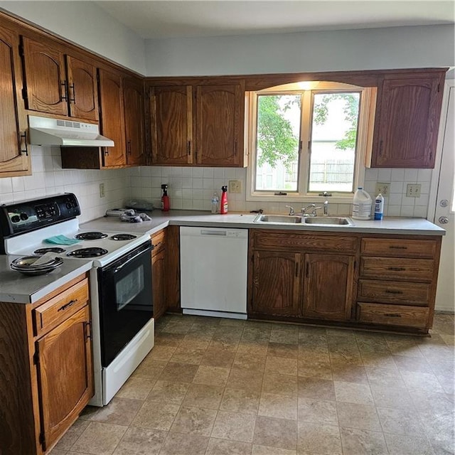 8413-8415 E 170th St, Belton, MO 64012 - kitchen featuring electric stove, dishwasher, under cabinet range hood, a sink, and backsplash