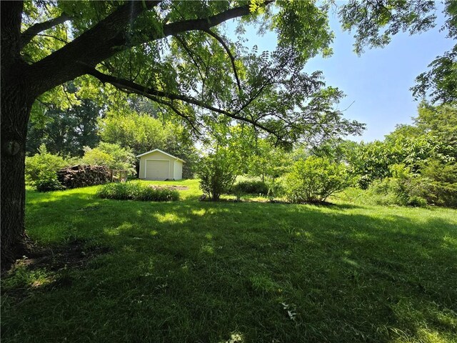 16280 Nall Ave, Stilwell, KS 66085 - view of green lawn featuring a garage and an outbuilding