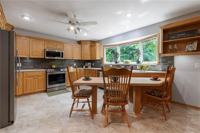 16280 Nall Ave, Stilwell, KS 66085 - kitchen featuring stainless steel appliances, decorative backsplash, ceiling fan, light countertops, and light floors