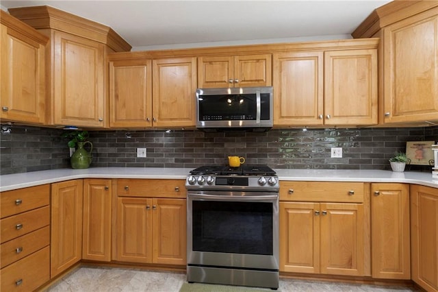 16280 Nall Ave, Stilwell, KS 66085 - kitchen featuring appliances with stainless steel finishes, light countertops, and decorative backsplash