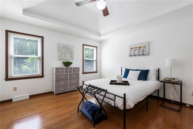 16280 Nall Ave, Stilwell, KS 66085 - bedroom featuring wood finished floors, a raised ceiling, and ceiling fan