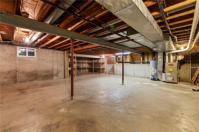 16280 Nall Ave, Stilwell, KS 66085 - unfinished below grade area featuring heating unit, gas water heater, and stairs