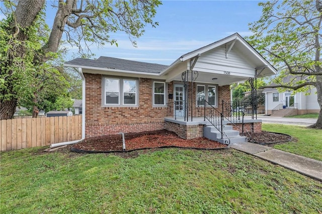1508 SW Smith St, Blue Springs, MO 64015 - view of front facade featuring brick siding, covered porch, and roof with shingles