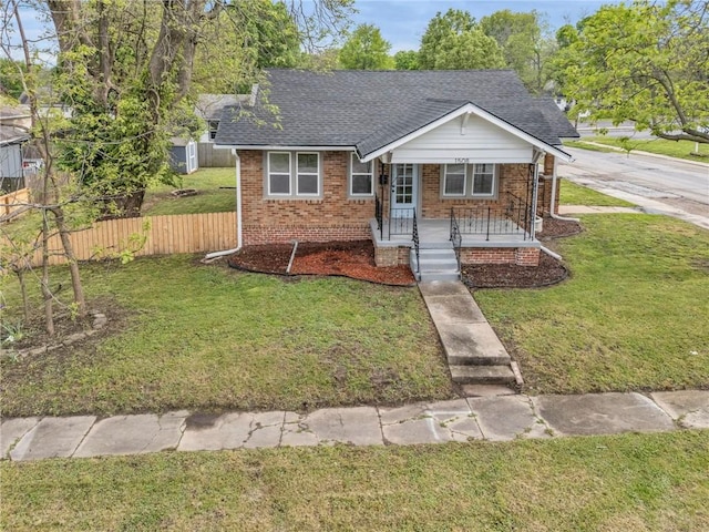 1508 SW Smith St, Blue Springs, MO 64015 - view of front facade featuring a shingled roof, covered porch, and brick siding