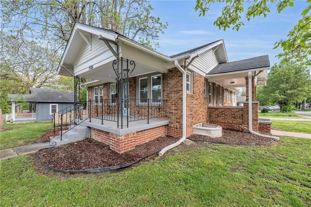 1508 SW Smith St, Blue Springs, MO 64015 - view of front of house with a porch, a front lawn, and brick siding