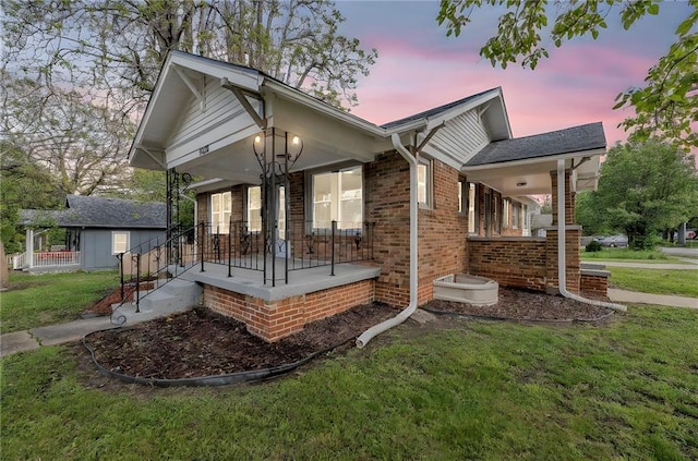 1508 SW Smith St, Blue Springs, MO 64015 - view of front of house with a porch, a front yard, and brick siding