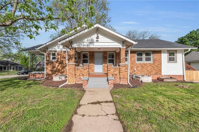 1508 SW Smith St, Blue Springs, MO 64015 - view of front of property with a front lawn, covered porch, and brick siding