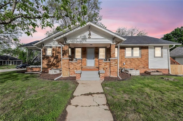 1508 SW Smith St, Blue Springs, MO 64015 - bungalow-style house with a front lawn, covered porch, and brick siding