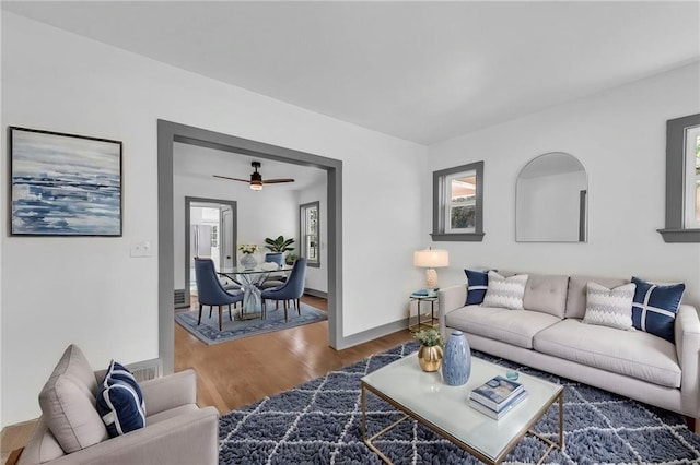 1508 SW Smith St, Blue Springs, MO 64015 - living room with wood finished floors, a ceiling fan, and baseboards