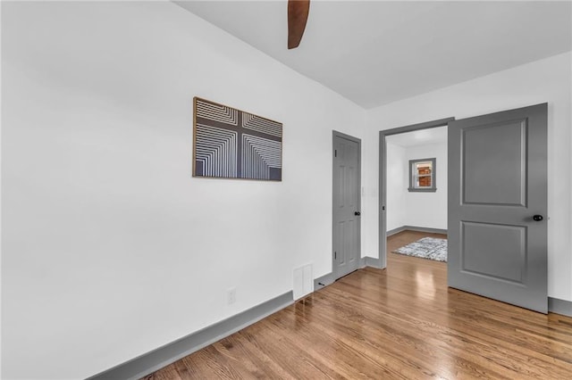 1508 SW Smith St, Blue Springs, MO 64015 - spare room featuring ceiling fan, wood finished floors, and baseboards