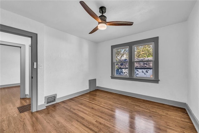 1508 SW Smith St, Blue Springs, MO 64015 - empty room with wood finished floors, a ceiling fan, and baseboards