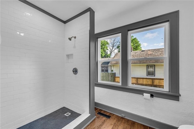 1508 SW Smith St, Blue Springs, MO 64015 - bathroom with tiled shower and wood finished floors