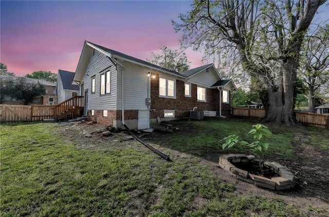 1508 SW Smith St, Blue Springs, MO 64015 - back of house featuring cooling unit and an outdoor fire pit