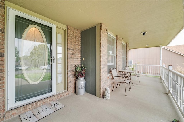 view of exterior entry featuring brick siding
