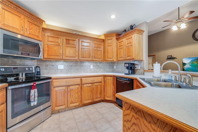 kitchen featuring stainless steel appliances, a sink, decorative backsplash, ceiling fan, and recessed lighting