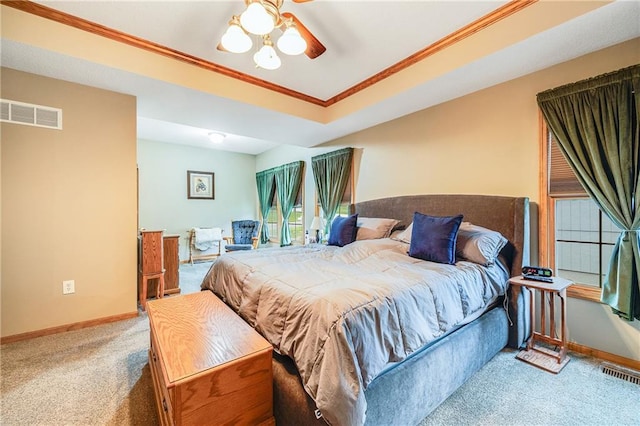 carpeted bedroom with ornamental molding, baseboards, and a ceiling fan