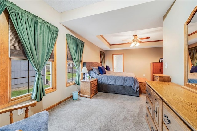 bedroom with light colored carpet, baseboards, and a ceiling fan